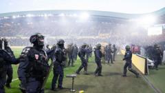 Ligue 1 game abandoned after fans invade pitch at relegated Nantes