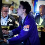Dow touches record high as oil slides further